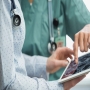 Female doctor nurse reviewing brain scan digital tablet