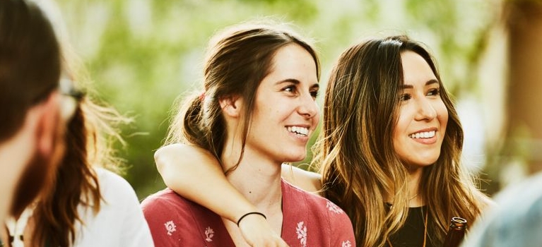 young women in friendly embrace