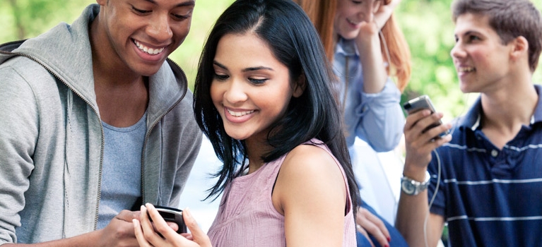 Teens interacting with smartphones